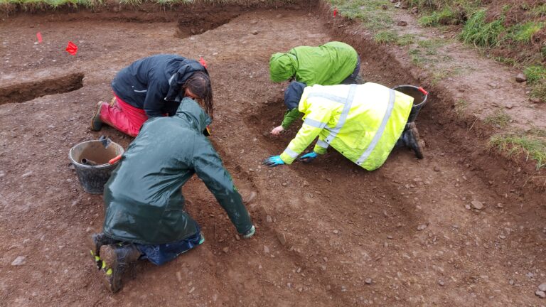 Digging the grave features at Thirlestane Barrows in the rain